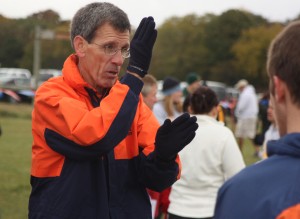 Before the Sunflower League meet on Oct.. 17, Coach Van Rose explains the route of the course to a varsity runner.