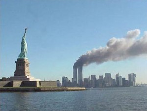 Lady Liberty looks toward Manhatten island shortly before the World Trade Center towers collapse to the ground.