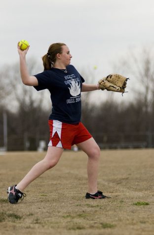 Freshmen Katt Cooper throws the  ball while playing catch at try-outs on March 20.