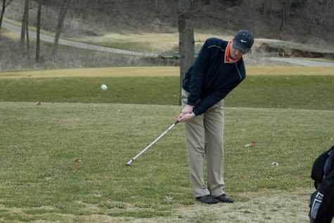 Senior Brett Lightle chips from the rough during practice at Shawnee Country Golf and Country Club.