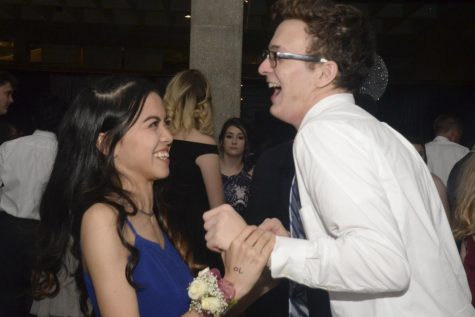 Senior Althea Flores shares a laugh with her date. 