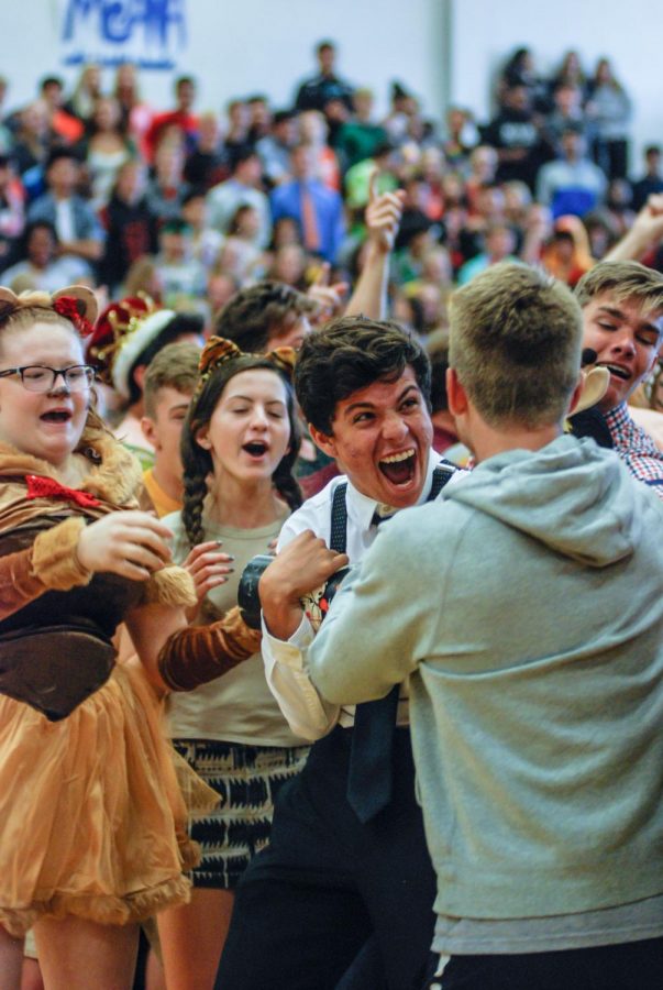 Senior Josh Sherfy with Spirit Club Exec board carries the spirit stick away from the senior class Oct. 20 in the main gym. The senior class won the spirit stick for the first time this year. 