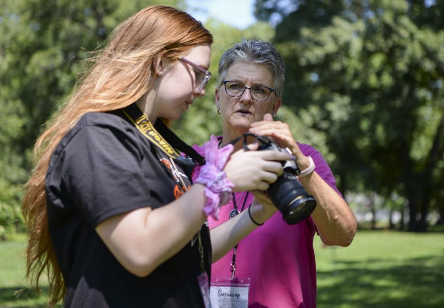 Instructor Mary Schulte  provides feedback on light settings to beginning photojournalist Claire Moore. 