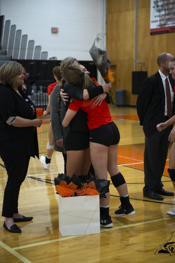 Senior Rylee Garrett and Freshman Tori Creason embrace each other during Senior Night Oct. 18 in the Main Gym. The seniors recieved a gift bag and flowers from the team to show their appriciation for them. “Being able to play with Tori is special becuase I played with her older sister Sabrina Creason for my first two years on varsity,” Garrett said. “I’m glad I can give the gidence that Sabrina gave me, to Tori.”