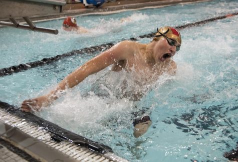 Junior Brian Harrell open turns at the wall Jan. 13 at the NW Pool. Harrell qualified for state in the 100 yard butterfly with a time of 56.6. “I swim butterfly because I feel strong,” Harrell said. “When I’m swimming I think about my breath and my turns, and at the end of a race, I think about my coach telling me to push myself.”