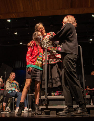 With a smile, band director Penny Snead hugs junior Lilly Harris Dec 6 in the Greg Parker Auditorium. ”[My greatest success as a teacher is] the relationships that I built with students,” Snead said. “Maybe even through music.” + photo by Evan Johnson