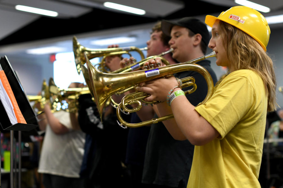 With her mellophone raised, freshman Jadyn Nogelmeier plays Hawaii 5-0 July 26 in the band room. Nogelmeier was dressed up as a minion for her section’s bald cap day. “A big takeaway from camp was Mr. Eichman telling us that in band we’re a family,” Nogelmeier said. “I’m excited to see what comes next once school starts!”
