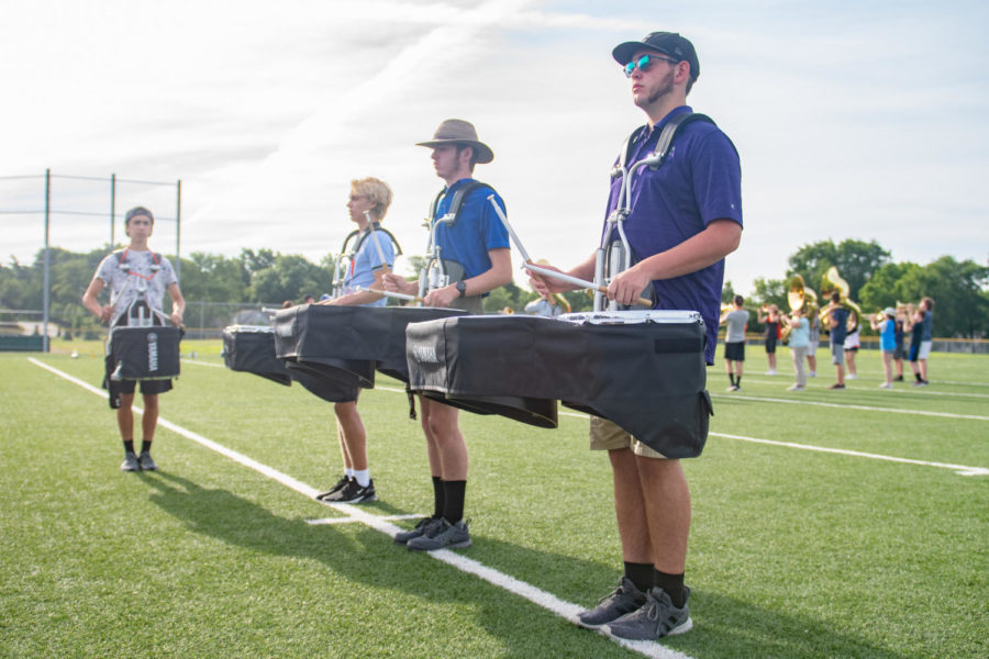 Senior+Tanner+Pruter+beats+on+the+tenor+drum+July+29+on+the+Northwest+football+field.+Pruter+and+the+other+tenors+practice+staying+together+as+a+group+when+playing.+%E2%80%9CI+think+band+camp+is+the+most+important+part+of+the+season%2C%E2%80%9D+Pruter+said.+%E2%80%9CIt+determines+how+good+our+shows+will+be.%E2%80%9D+
