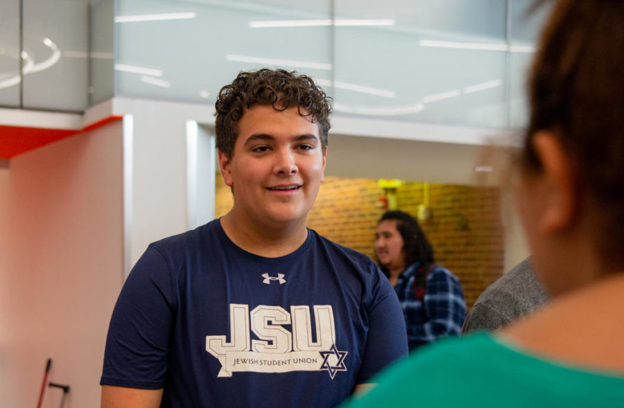Junior Tad Lambert talks to senior Nevaya Davis about Jewish Student Union (JSU) Sept. 8 in the mall. JSU is a club for Jewish and non-Jewish people to get together and talk about Jewish culture and hangout. “I have thought about [starting JSU] since the end of my freshman year,” Lambert said. “At the beginning of sophomore year I just said let’s do it,” photo by Ashley Broils 