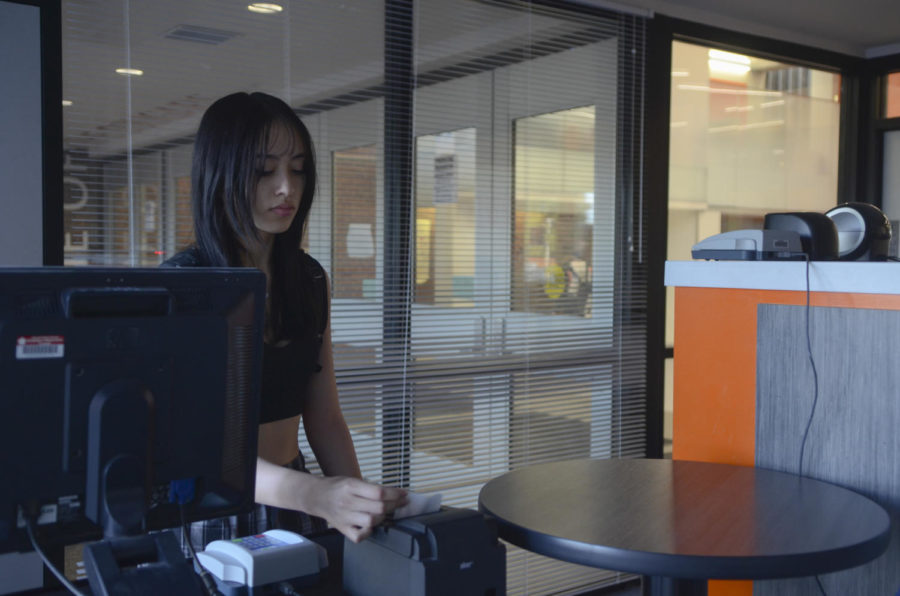 After arriving late on Oct. 6, senior Bella Gonzalez takes the tardy pass that she will need to present to her teacher.. After the bell rings, late students form a line in at west end of the mall as they wait to get to the tardy kiosk. “I struggle to wake up in the morning even with the loudest alarm,” Gonzalez said. “I think it helps prevent students being counted absent. A tardy isn’t as impactful on a students record than an absent.”