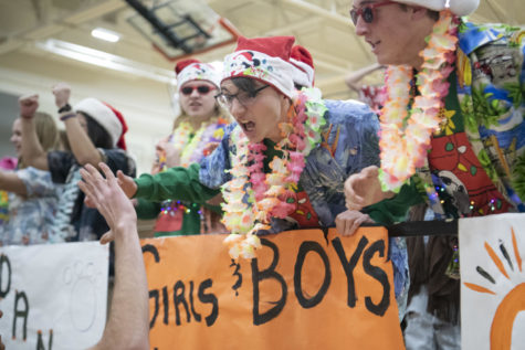 Sophomore Gustin Teschendorf high-fives senior Evan Mitchell Dec. 1 in the Main Gym. The band’s theme was Tropical Christmas. “I loved the band theme in particular,” Teschendorf said. “It goes hand in hand with our upcoming Disney trip we’re going on during break.” 