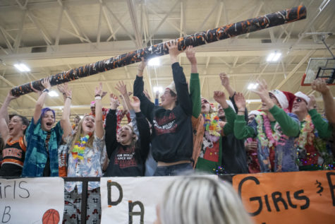Freshmen Ian Murdock, Avery Cornelius and seniors Alexis Petry and Dylan Reed hold up the spirit stick Dec. 1 in the Main Gym. It was awarded to the band by judges due to their support of other groups. “In the moment, there was so much adrenaline and just pure energy,” Reed said. “Last year at [the Sweetheart assembly], we were a skit away from winning and I was hoping to run it back” 