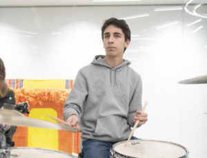 Sophomore Javier Cruz  plays the drums during the Thursday Morning Open Mic jazz performance Nov. 17 in the mall. The jazz band performed Work Song by Cannonball Adderly and Sonnymoon for Two by Sonny Rollins. “Jazz is my favorite genre and I have the most experience playing it,” Cruz said. “There are a lot of rules to it, but the better you get at it, you can start to break the rules and that’s when the fun really starts.”