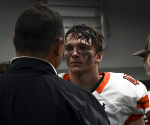 Grieving the loss of the final football game, sophomore Jonty Harris-Webster talks with coach Brian Vesta Oct. 28 in the Blue Valley West Football Locker Room. The Cougars lost to the Jaguars 28-52. “It was a tough loss,” Harris-Webster said, “Knowing that you won’t be playing with some of the seniors and your brothers is very raw and emotional.”