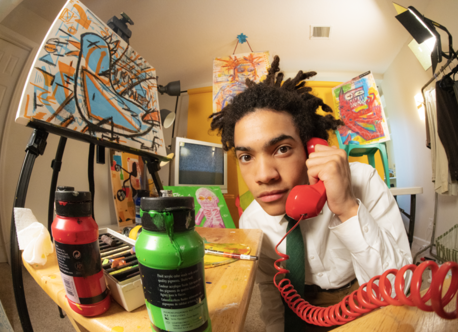 Senior Evan Johnson sits in his creative studio Feb. 20 at his house. After his sister moved out of the house to attend college, Johnson repurposed the room as a space to work on creative projects.