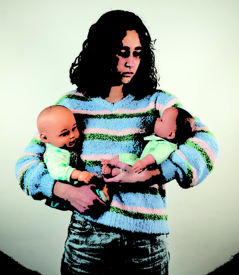Sophomore Sophie Delaney holds two baby dolls Feb. 23 in Room 151. Delaney feels there’s a pressure for women to have children and get married as soon as possible. 