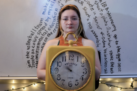 Senior Veronica Meiss holds a clock in Room 151. 
