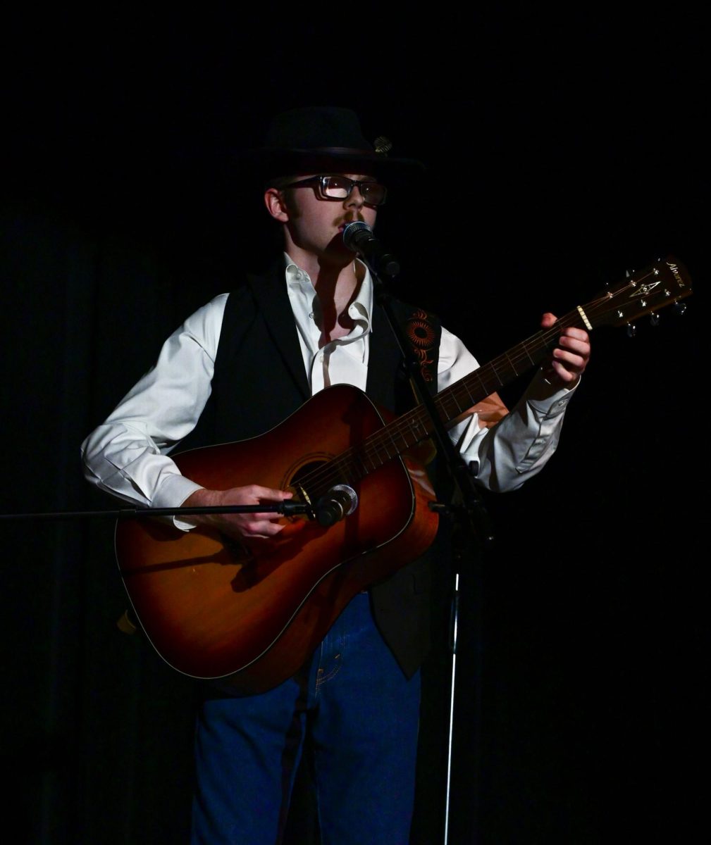 Singing an original song, senior Brett Charlton performs at the Talent show March 19 in the Auditorium. The song was dedicated to his ex. Photo by Ashley Broils
