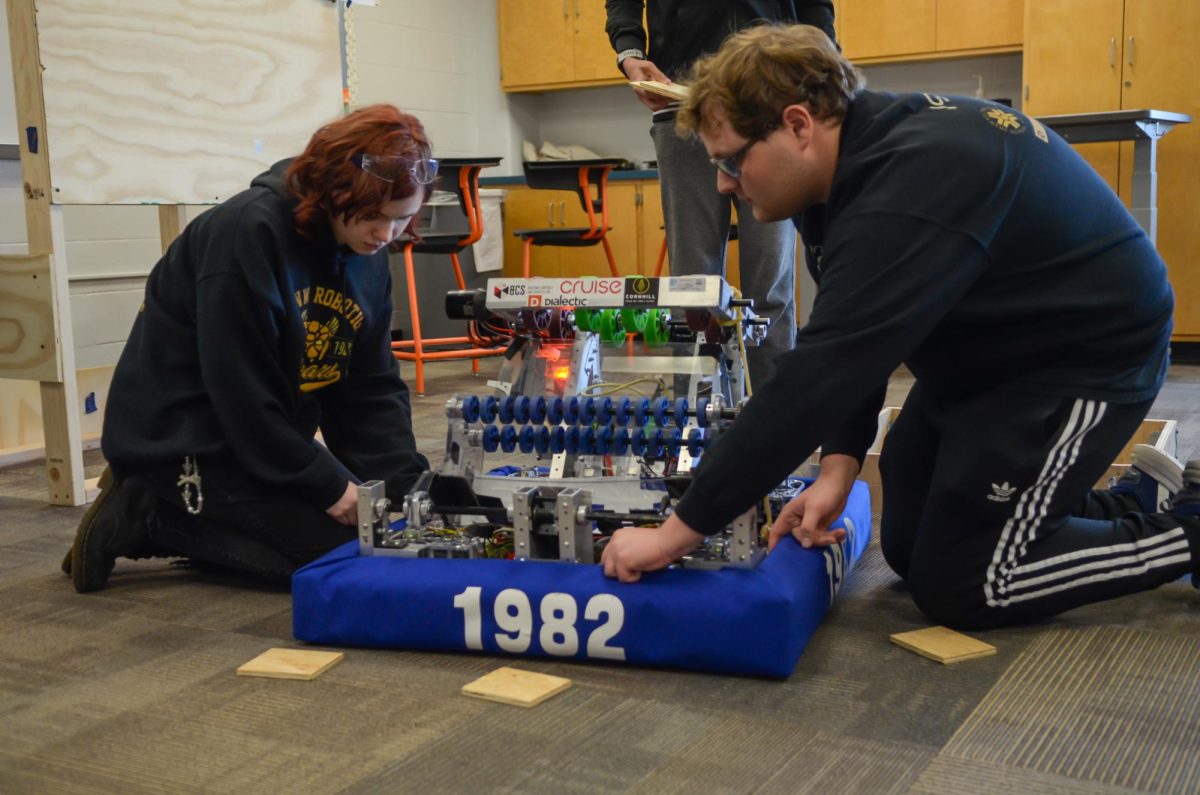 Junior+Venti+Neaderhiser+and+senior+Dylan+Paflas+work+on+their+robot+March+21+in+Room+C.+The+robotics+team+worked+on+their+robot%2C+Fred%2C+to+prepare+for+the+FRC+Worlds+competition.+%E2%80%9CI+was+working+with+the+bumpers+on+our+robot+that+protect+%5Bthe%5D+frame+%5Bfor%5D+when+we+hit+or+bump+into+something%2C%E2%80%9D+Neaderhiseri+said.++%E2%80%9CWe+have+put+a+lot+of+work+into+building+and+coding+the+robot+and+have+run+into+many+difficulties+but+we+have+overcome+every+issue.%E2%80%9D+photo+by+Jack+Pischke