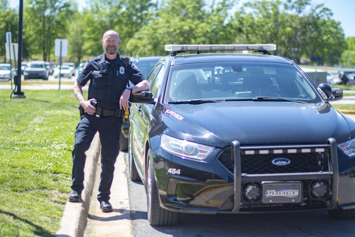 Student resource officer Mark Coenen leans on his car April 29 in the Student Parking Lot. photo by Cooper Evans