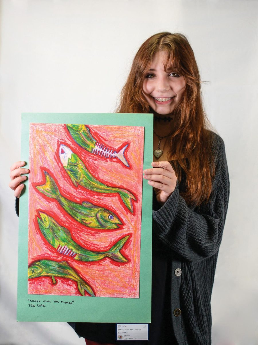 Junior Ella Cole stands with her art Aug. 30 in room 151.