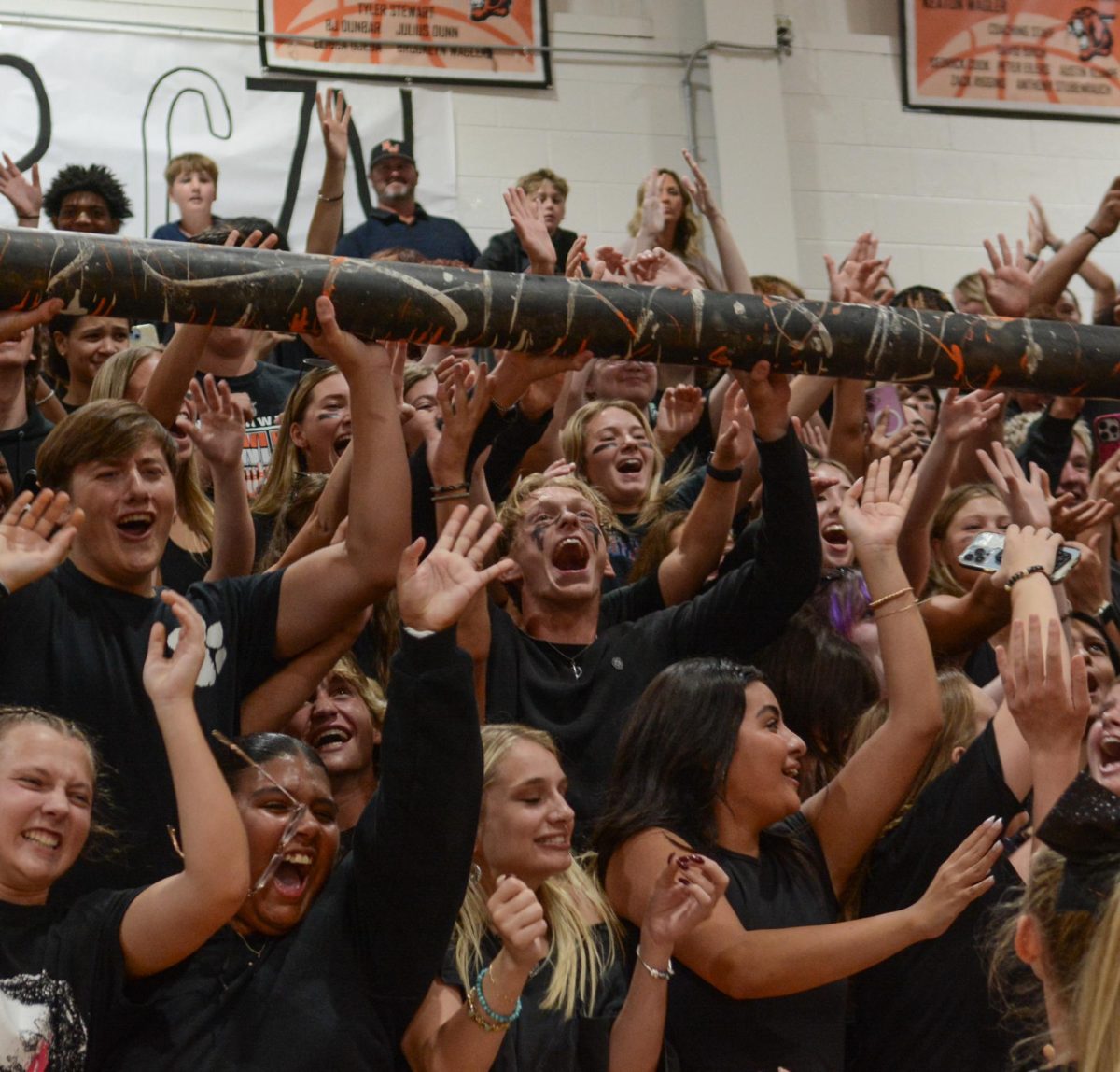 Cheering, senior Mason Whitmore holds the spirit stick Sept. 3 in the Main Gym. The spirit stick is awarded by judges to whichever class shows the most spirit during the assembly. “It was my first time being there when we won it, I missed the first assembly we won last year,” Whitmore said “It was fun and exciting and I’m just glad I was actually there this time.”