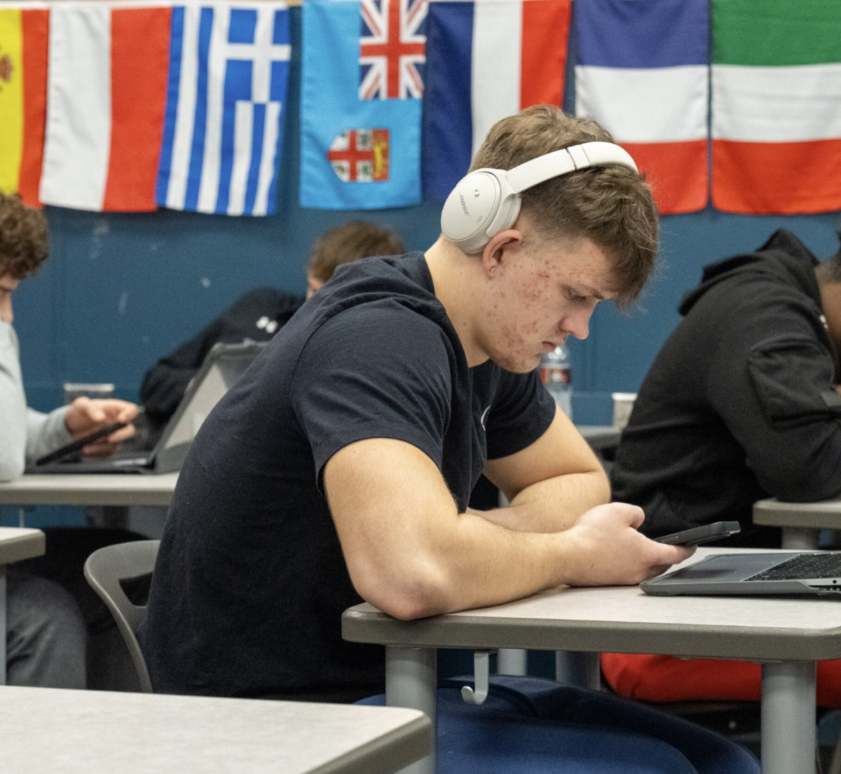 Looking down, senior Braydon Siverston watches his phone Jan.16 in Room 133. During instructional time, students are told to have their phones away, however some teachers do not consistently enforce this, or notice.