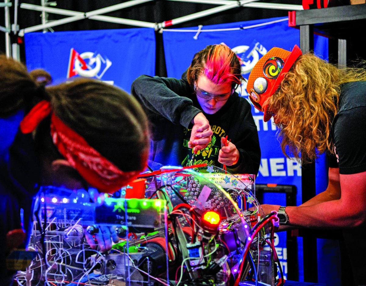 In between matches, Sophomore Ronan Jones helps fix the robot on April 11 at Lee Summit North High School. It can be stressful at times during competitions and between matches. “We have to work really fast, sometimes very stressful, because sometimes the robot breaks…, so we have to get it fixed. Jones says.